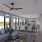 Penthouse living room with large windows and ceiling fan at The Drake