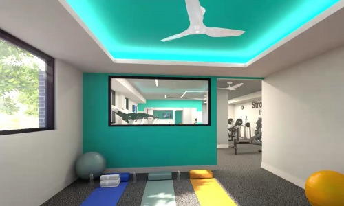Spacious fitness center with large windows for light and numerous equipment at The Drake Apartments