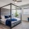 Spacious carpeted bedroom with ceiling fan at The Drake