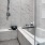 Spacious walk in tub and shower combo with wall stool in apartment homes at The Drake