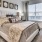 Spacious and well lit bedroom with plush carpet and large windows at The Drake