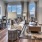 Spacious and well lit living room with wood floors and large windows with a view at The Drake