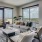 Apartment living room with large windows and door to balcony at The Drake